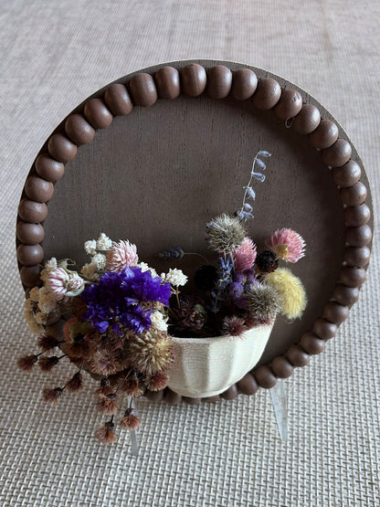 Small board with pottery and dried flowers